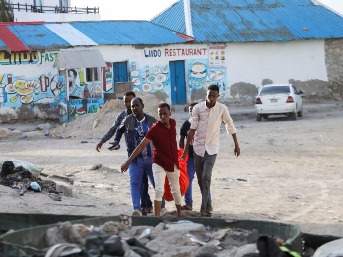 At least 32 killed in suicide bomb and gun attack