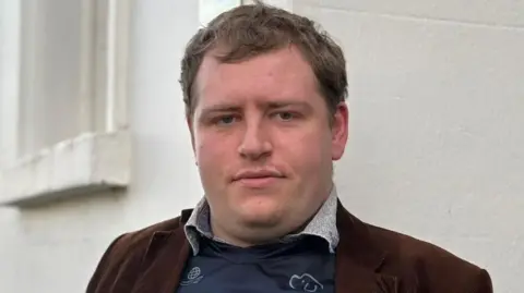 Lois Worrow/BBC A man standing outside with his 